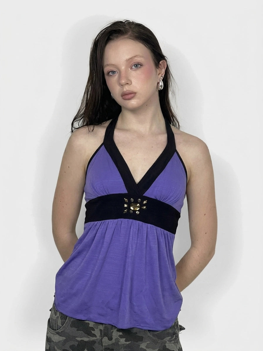 Front view of a purple women's top with a black band and decorative detail.